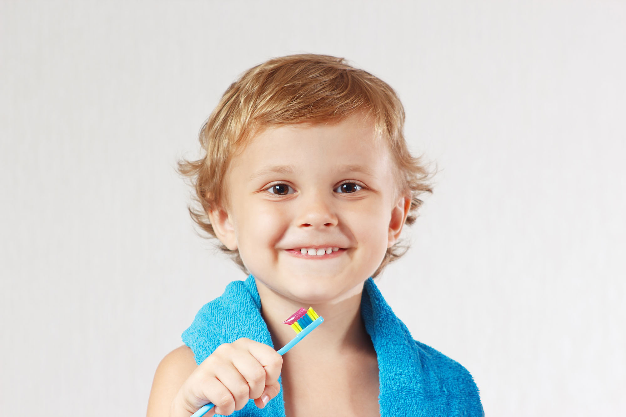 Young cute blond boy with toothbrush with pink toothpaste | Quality dental care for children